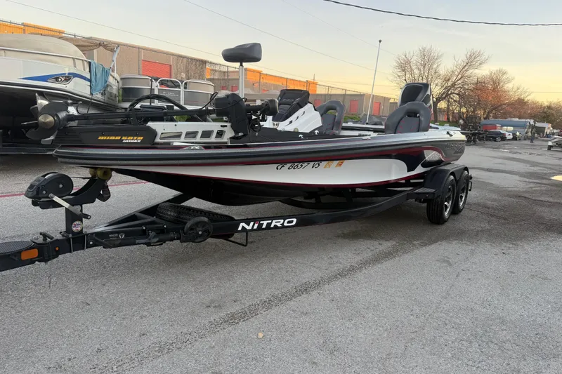 Slide: The Image of 2020 Nitro Z20 boat on trailer at sunrise by a lake. - 1