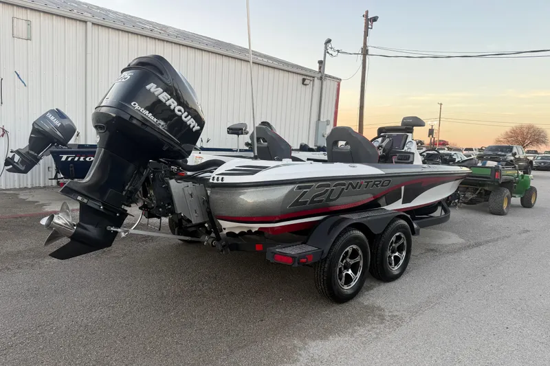 Slide: The Image of 2020 Nitro Z20 boat with powerful 225 engine on trailer in parking lot. - 11