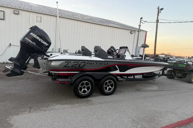 Slide: The Image of Rear view of a 2020 Nitro Z20 boat with a 225 horsepower engine in a parking lot. - 12