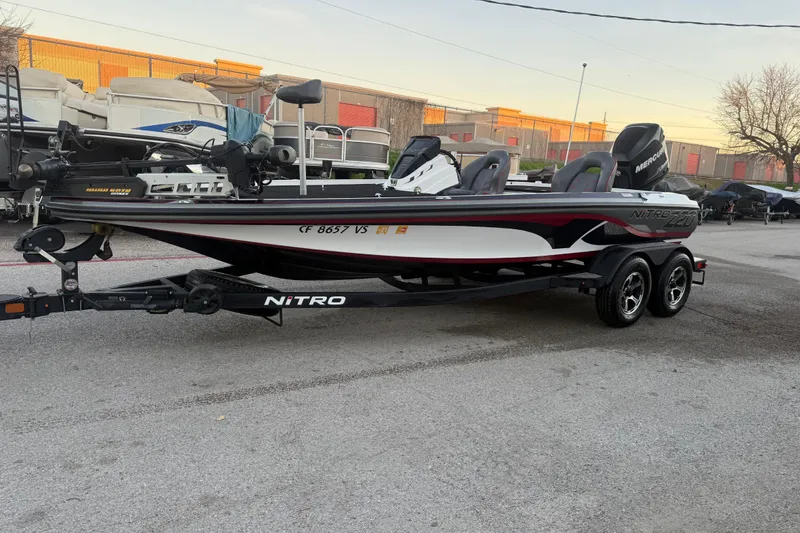 Slide: The Image of 2020 Nitro Z20 boat at sunset by a lake, on a trailer. - 3