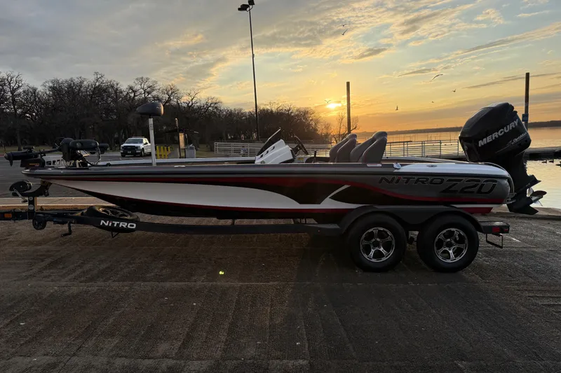 Slide: The Image of 2020 Nitro Z20 boat interior with gray and red seats, steering wheel, and controls. - 38