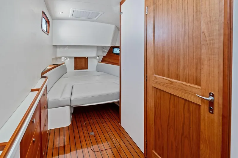 Slide: The Image of Luxurious cabin interior of 2025 MJM 4 yacht with wooden accents and cozy bed. - 15