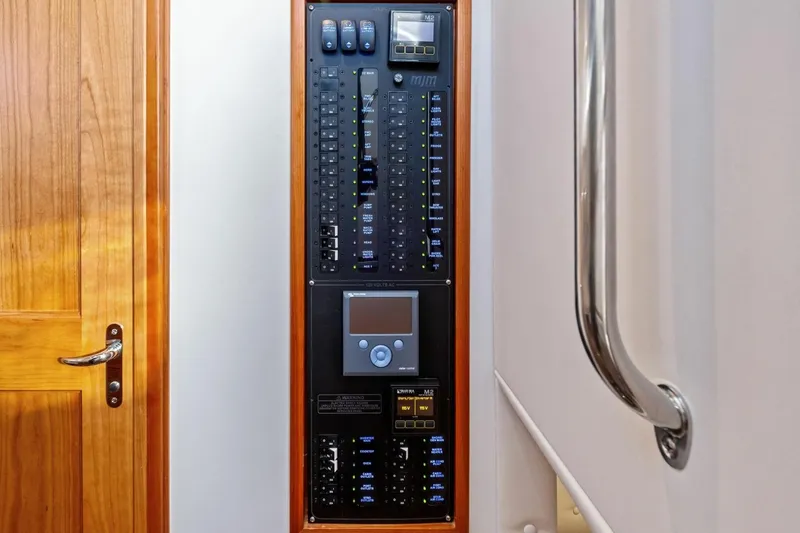 Slide: The Image of Electrical control panel on 2025 MJM 4 boat, featuring switches and display. - 22