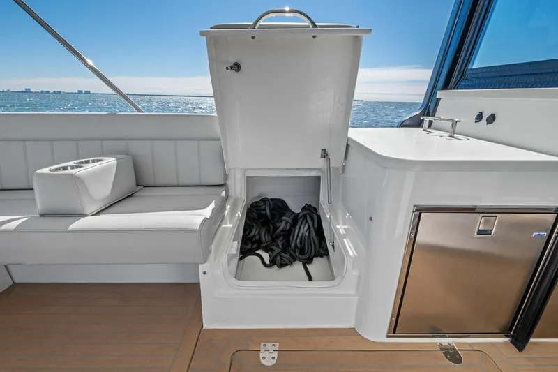 Slide: The Image of 2025 MJM 4 yacht interior with open storage compartment and ocean view. - 25