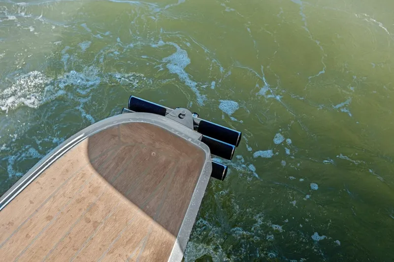 Slide: The Image of Sleek MJM 4 boat stern navigating through green waters, 2025 model. - 27