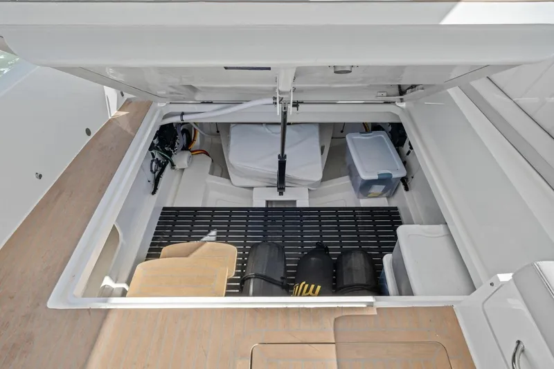 Slide: The Image of Storage compartment of 2025 MJM 4 boat, featuring organized equipment and gear. - 31