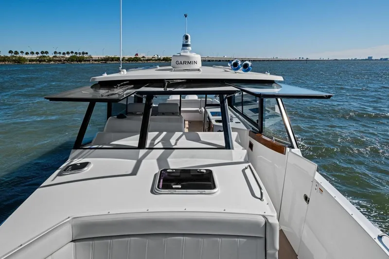 Slide: The Image of 2025 MJM 4 boat cruising on open water under clear blue skies. - 34