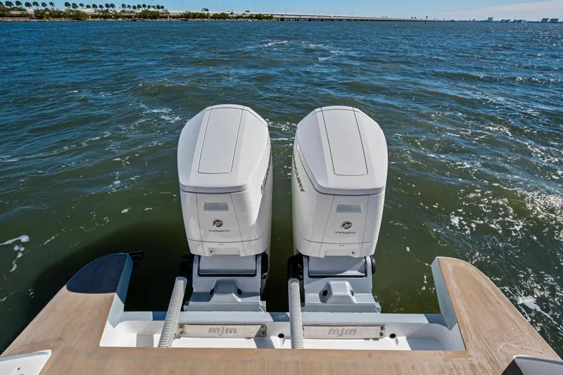 Slide: The Image of Twin outboard engines on 2025 MJM 4 boat, cruising on open water. - 39