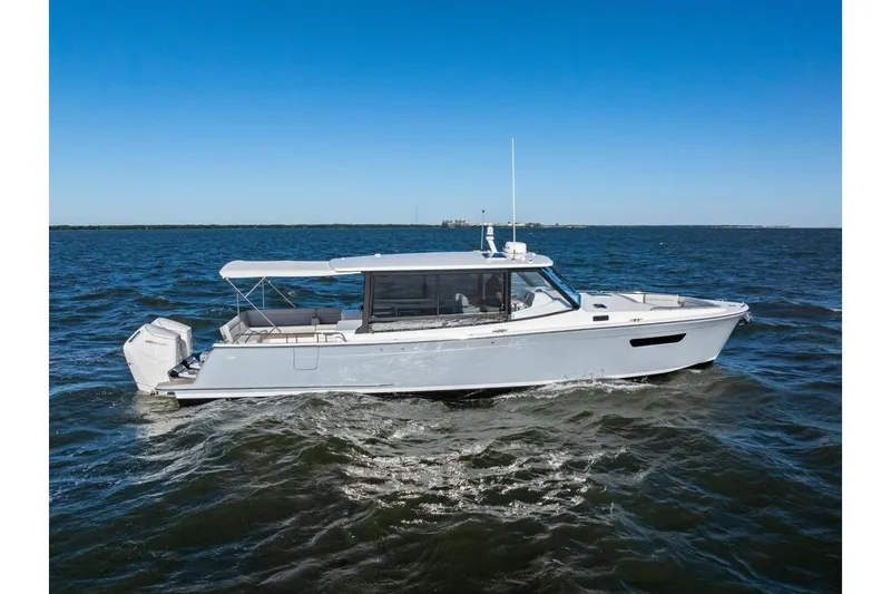 Slide: The Image of 2025 MJM 4 boat cruising on open water under clear blue sky. - 40