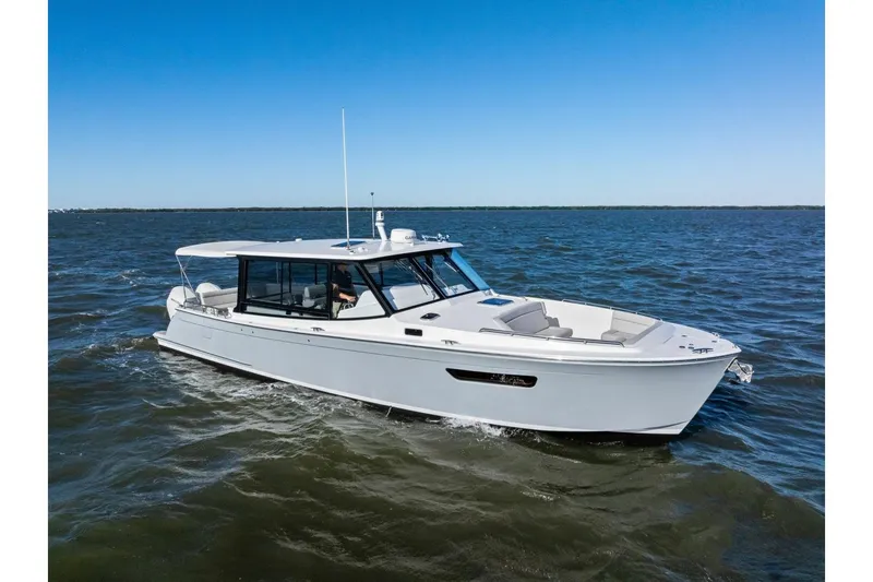 Slide: The Image of 2025 MJM 4 boat cruising on open water under clear blue skies. - 41