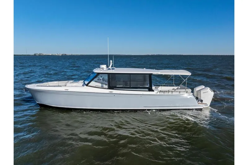 Slide: The Image of 2025 MJM 4 boat cruising on open water under clear blue sky. - 43