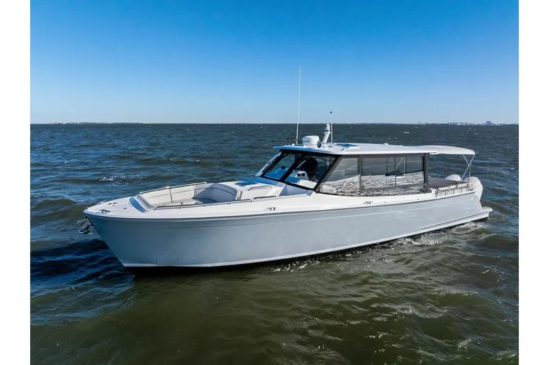 Slide: The Image of 2025 MJM 4 boat cruising on open water under clear blue skies. - 44