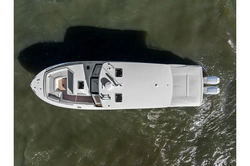 Slide: The Image of Aerial view of 2025 MJM 4 boat with dual engines on water. - 45