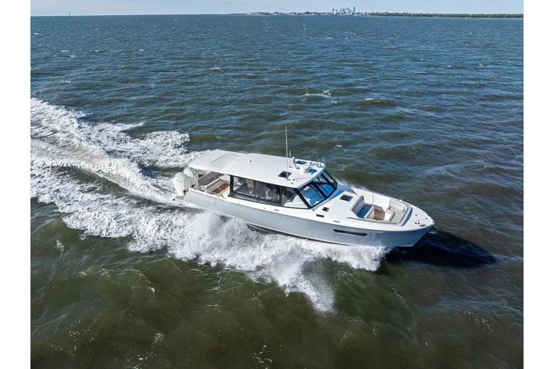 Slide: The Image of A 2025 MJM 4 boat cruising on open water, showcasing sleek design and performance. - 46