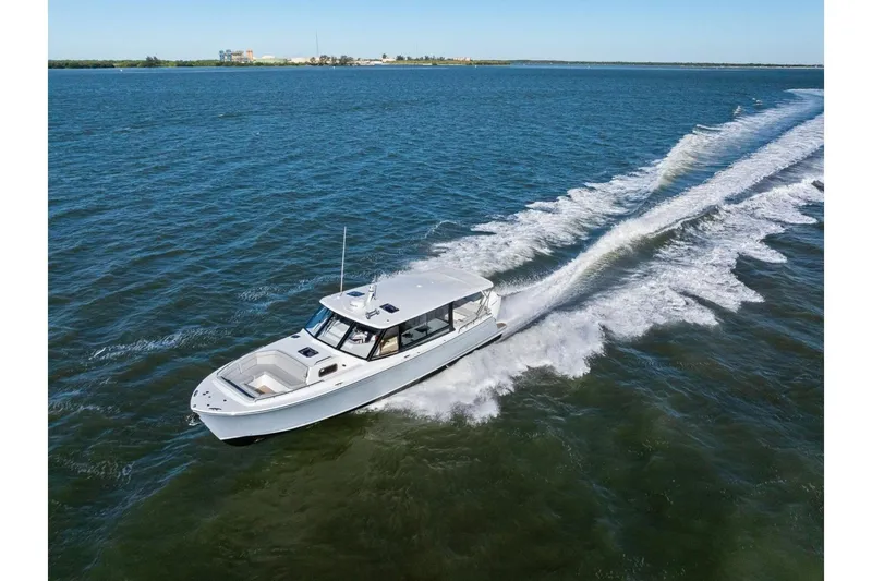 Slide: The Image of 2025 MJM 4 boat cruising on open water, leaving a trail of waves behind. - 48