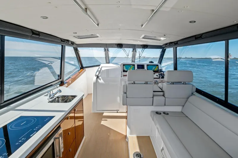 Slide: The Image of Luxurious interior of 2025 MJM 4 yacht with modern helm and kitchenette. - 6