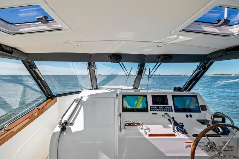 Slide: The Image of Interior view of 2025 MJM 4 boat cockpit with navigation screens and steering wheel. - 8