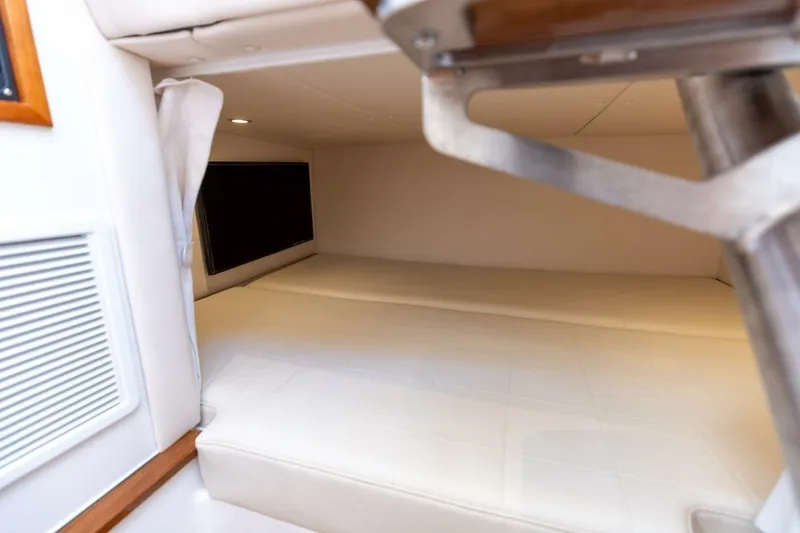 Slide: The Image of 2025 MJM 4 boat interior cabin with white cushioned seating and modern design. - 28