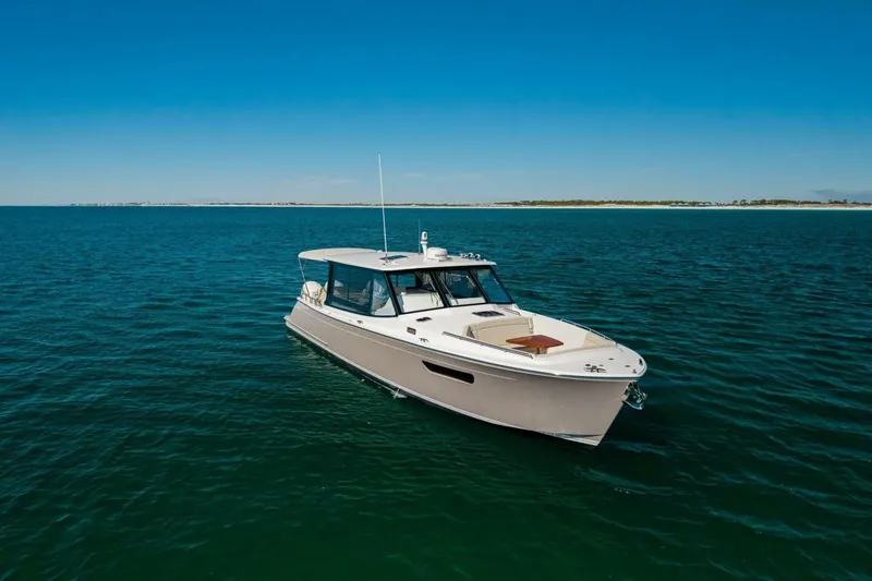 Slide: The Image of 2025 MJM 4 boat cruising on open water under clear blue sky. - 44