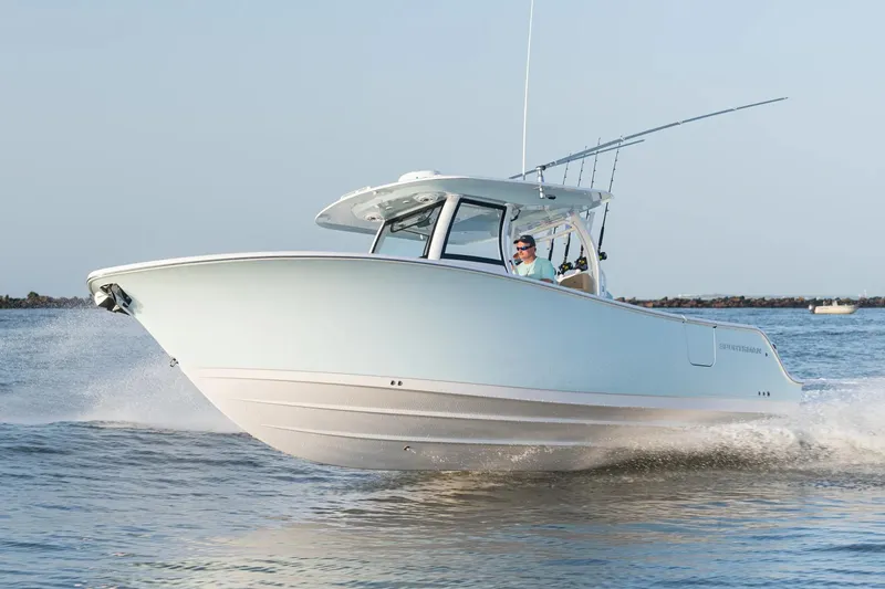 Slide: The Image of Manufacturer Provided Image: 2024 Sportsman Open 302 Center Console boat cruising on water. - 2