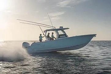 Slide: The Image of 2024 Sportsman Open 302 Center Console boat docked on a sunny day. - 5