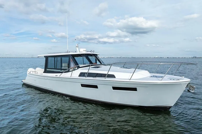 The Image of 2025 MJM 42 yacht cruising on calm waters under a partly cloudy sky. - 1