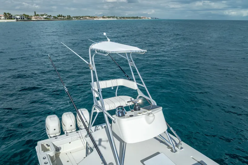 Slide: The Image of 2017 SeaVee 370Z boat with fishing rods, ocean view, and distant shoreline. - 10