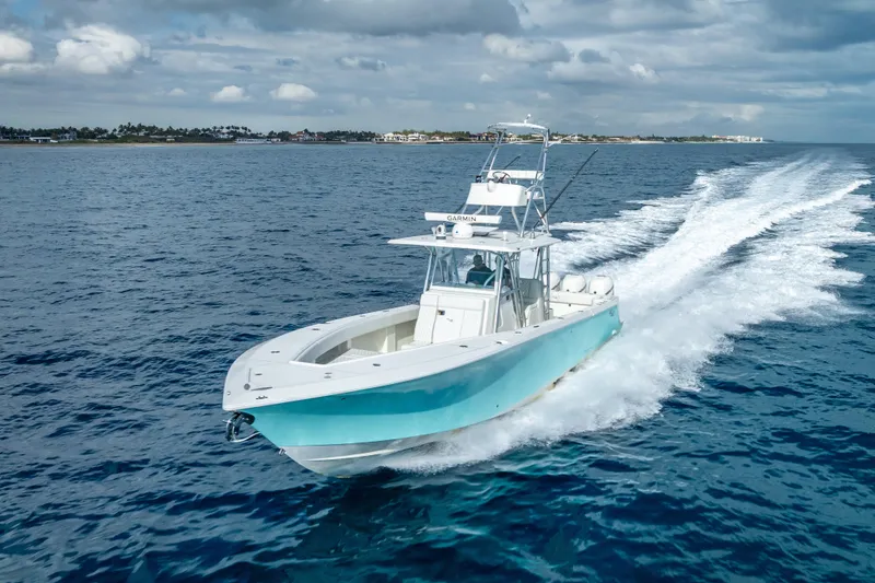 Slide: The Image of 2017 SeaVee 370Z boat cruising on open ocean under cloudy sky. - 13