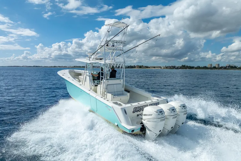 Slide: The Image of 2017 SeaVee 370Z boat cruising on open water with triple Mercury engines. - 15