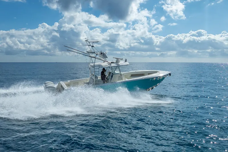 Slide: The Image of 2017 SeaVee 370Z boat cruising on open ocean under cloudy sky. - 18