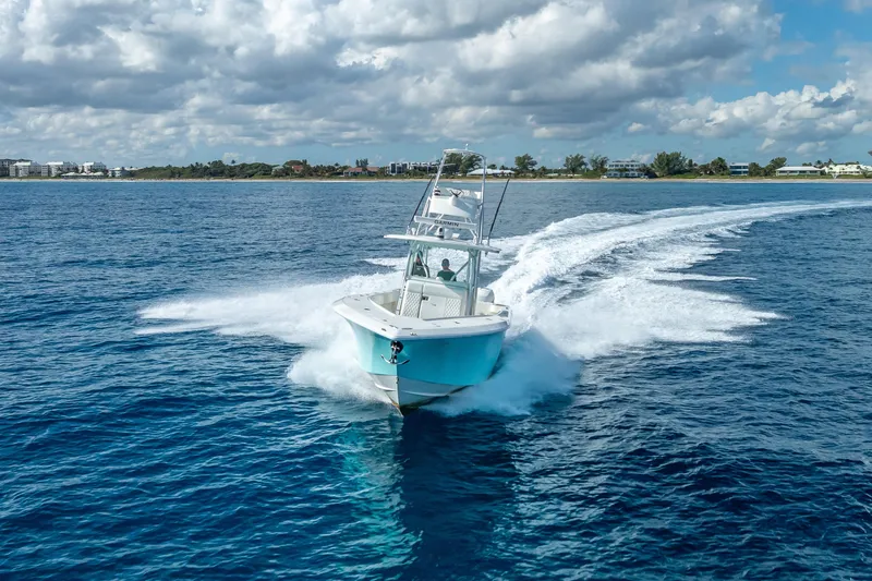Slide: The Image of 2017 SeaVee 370Z boat cruising on open blue water under cloudy sky. - 20