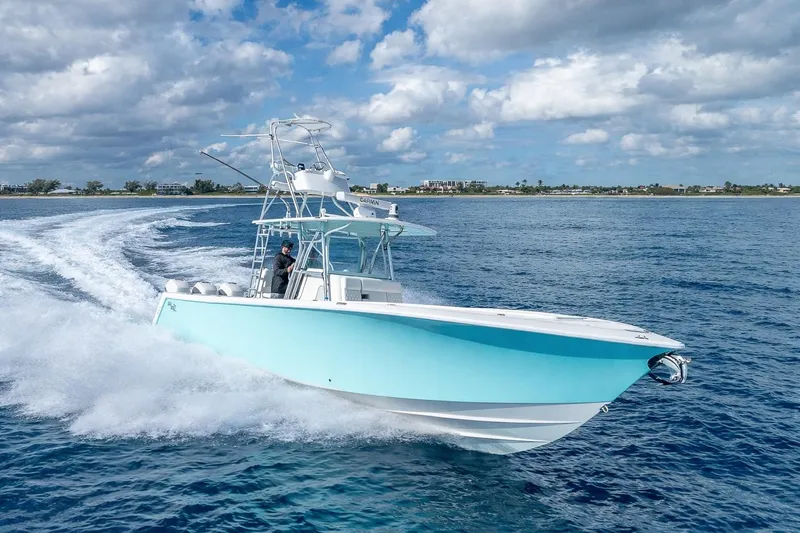 Slide: The Image of 2017 SeaVee 370Z boat cruising on open water under a partly cloudy sky. - 22