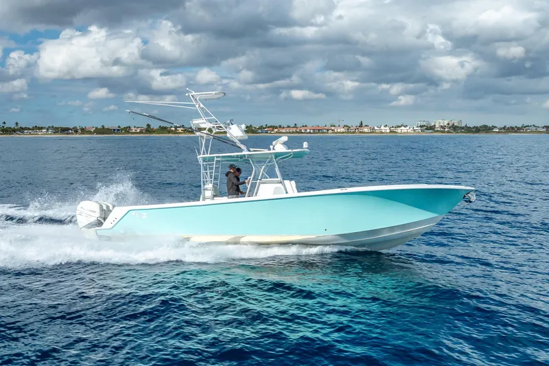 Slide: The Image of 2017 SeaVee 370Z boat cruising on open water under cloudy skies. - 24