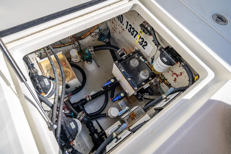 Slide: The Image of Engine compartment of 2017 SeaVee 370Z boat, showcasing mechanical components and wiring. - 25