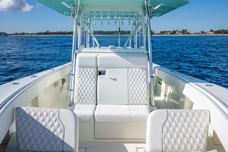 Slide: The Image of 2017 SeaVee 370Z boat interior with white seating, ocean view, and clear sky. - 37