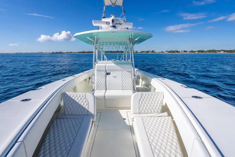 Slide: The Image of 2017 SeaVee 370Z boat on open water, featuring spacious seating and clear blue skies. - 38