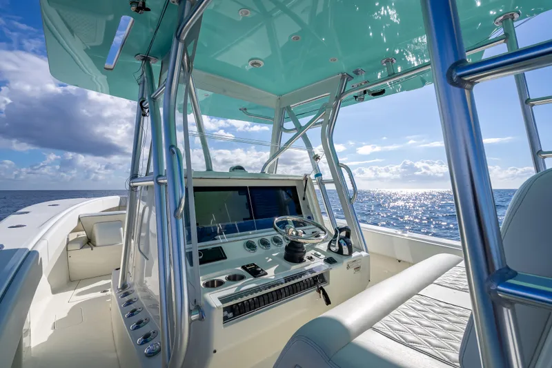 Slide: The Image of 2017 SeaVee 370Z boat interior with helm, ocean view, and clear sky. - 40