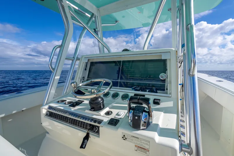 Slide: The Image of 2017 SeaVee 370Z boat console with steering wheel, ocean view, and clear blue sky. - 44