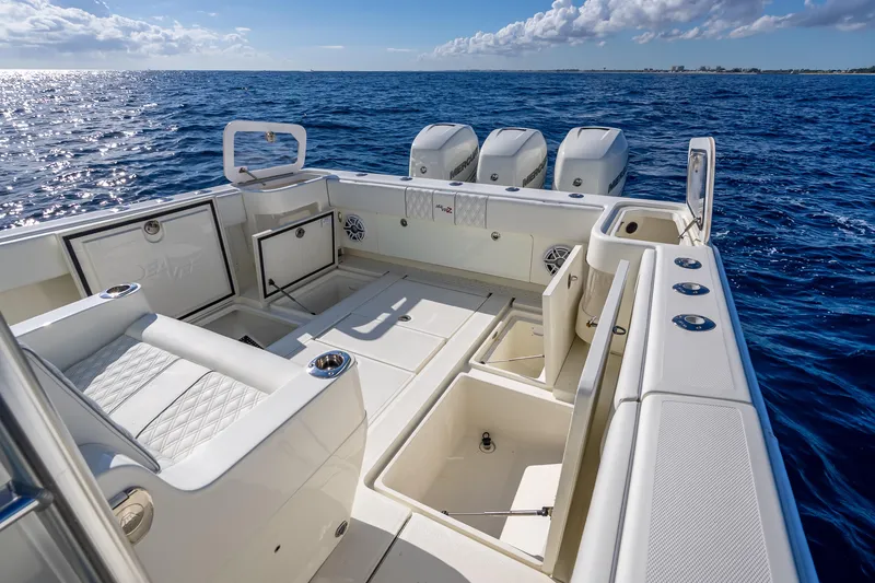 Slide: The Image of 2017 SeaVee 370Z boat deck with seating and storage, overlooking the ocean. - 49