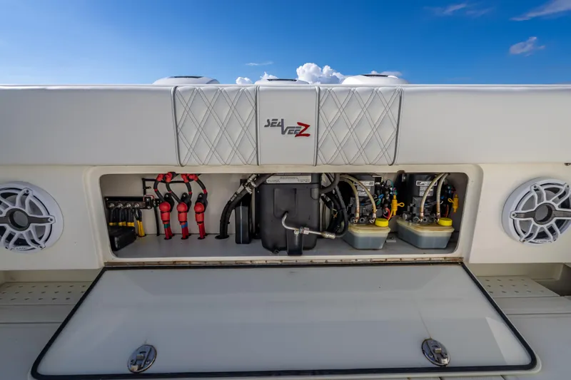 Slide: The Image of 2017 SeaVee 370Z boat storage compartment with equipment and speakers under a clear blue sky. - 51