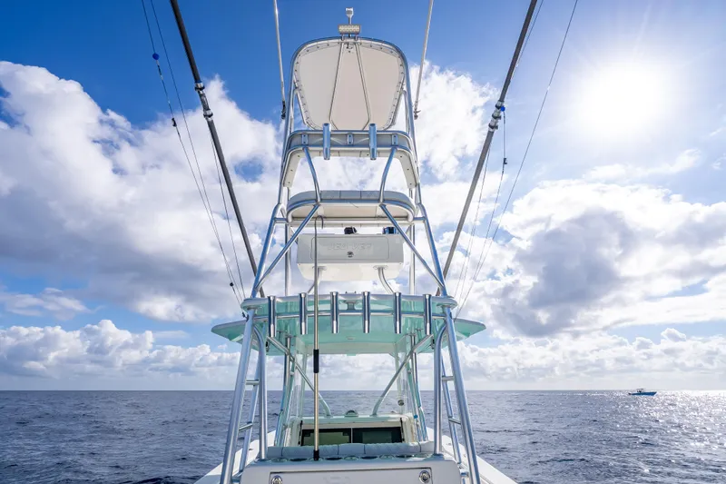 Slide: The Image of 2017 SeaVee 370Z boat with tower against a sunny ocean backdrop. - 56