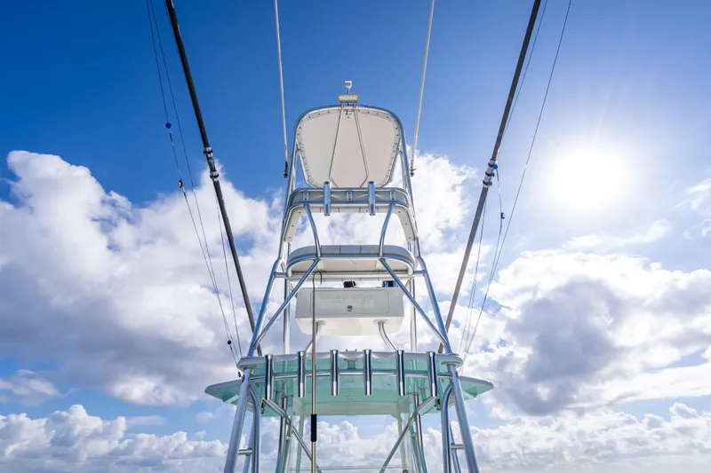 Slide: The Image of 2017 SeaVee 370Z boat tower against a bright blue sky with clouds. - 57
