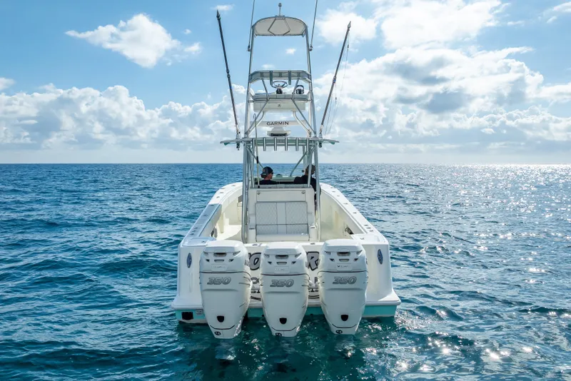 Slide: The Image of 2017 SeaVee 370Z boat with triple engines on open ocean under blue sky. - 8