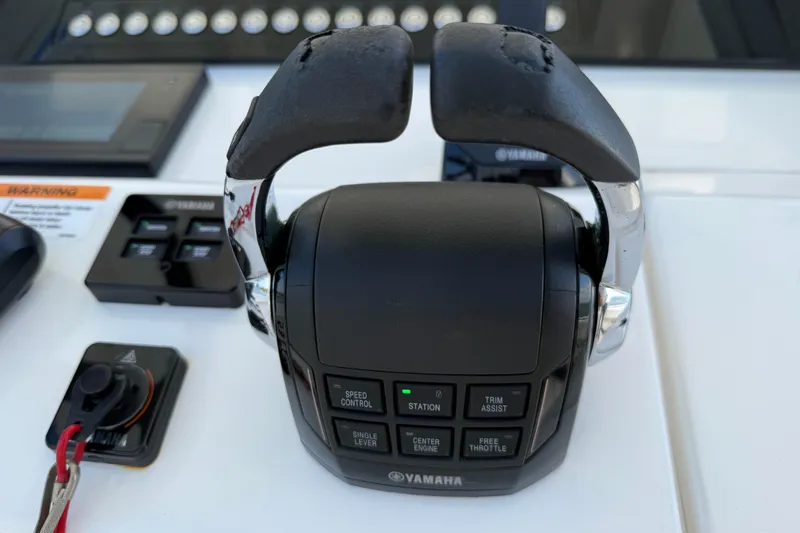 Slide: The Image of Yamaha throttle control on 2020 Regulator 31 boat dashboard with various control buttons. - 15