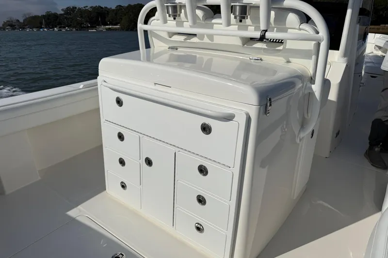 Slide: The Image of 2020 Regulator 31 boat with white storage console and rod holders on deck. - 21