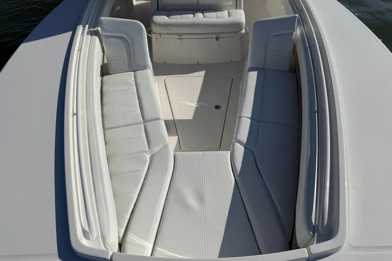 Slide: The Image of 2020 Regulator 31 boat interior with white cushioned seating and storage compartment. - 23