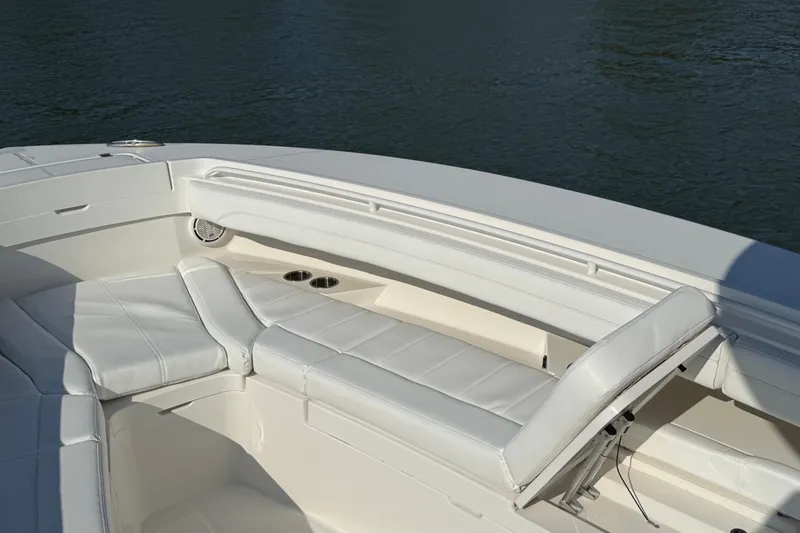 Slide: The Image of 2020 Regulator 31 boat interior with white cushioned seating and cup holders. - 25