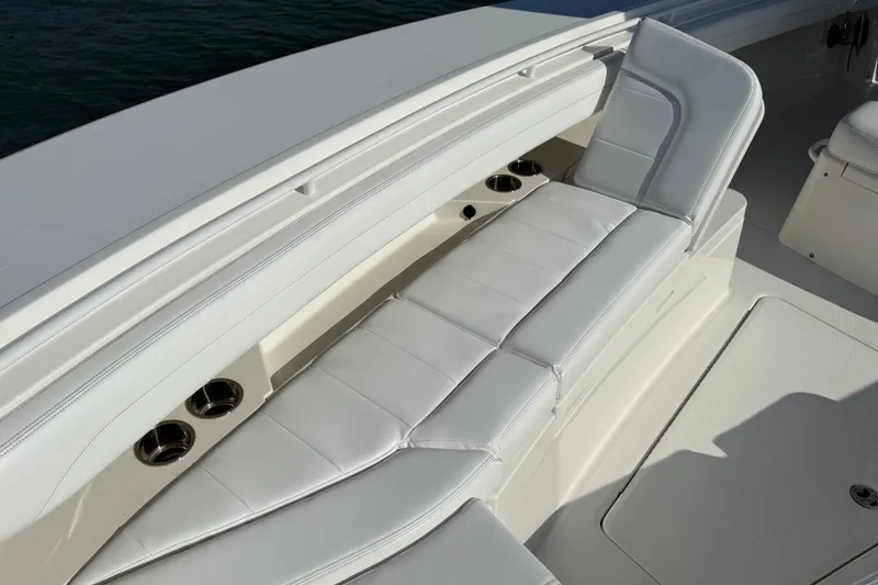 Slide: The Image of 2020 Regulator 31 boat with white cushioned seating and cup holders. - 27