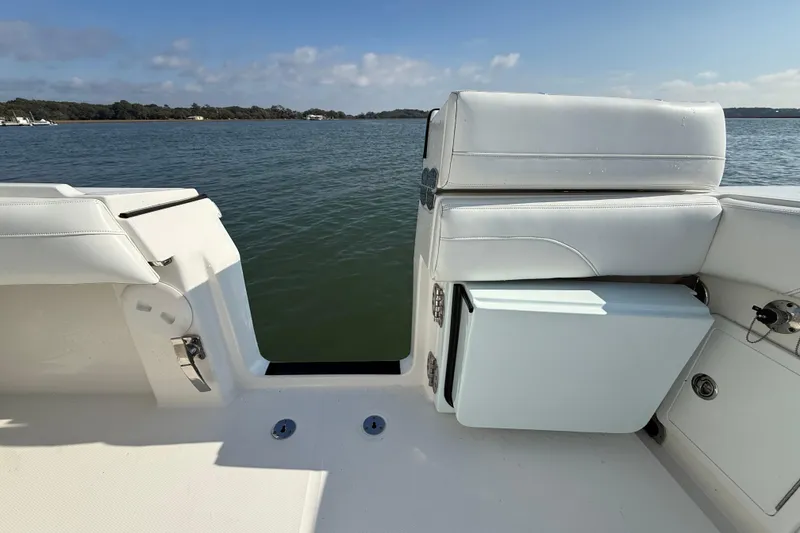 Slide: The Image of 2020 Regulator 31 boat interior with white seating, overlooking calm waters. - 38
