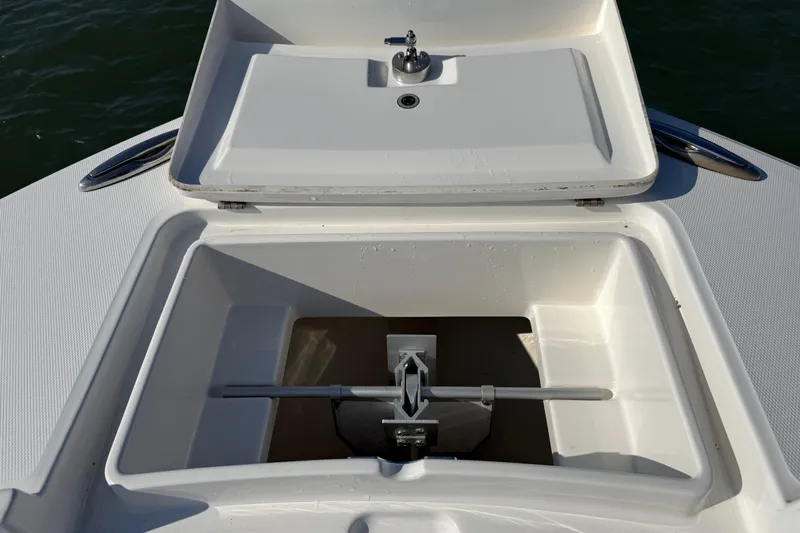 Slide: The Image of Anchor storage compartment on a 2020 Regulator 31 boat, featuring a clean, white design. - 41